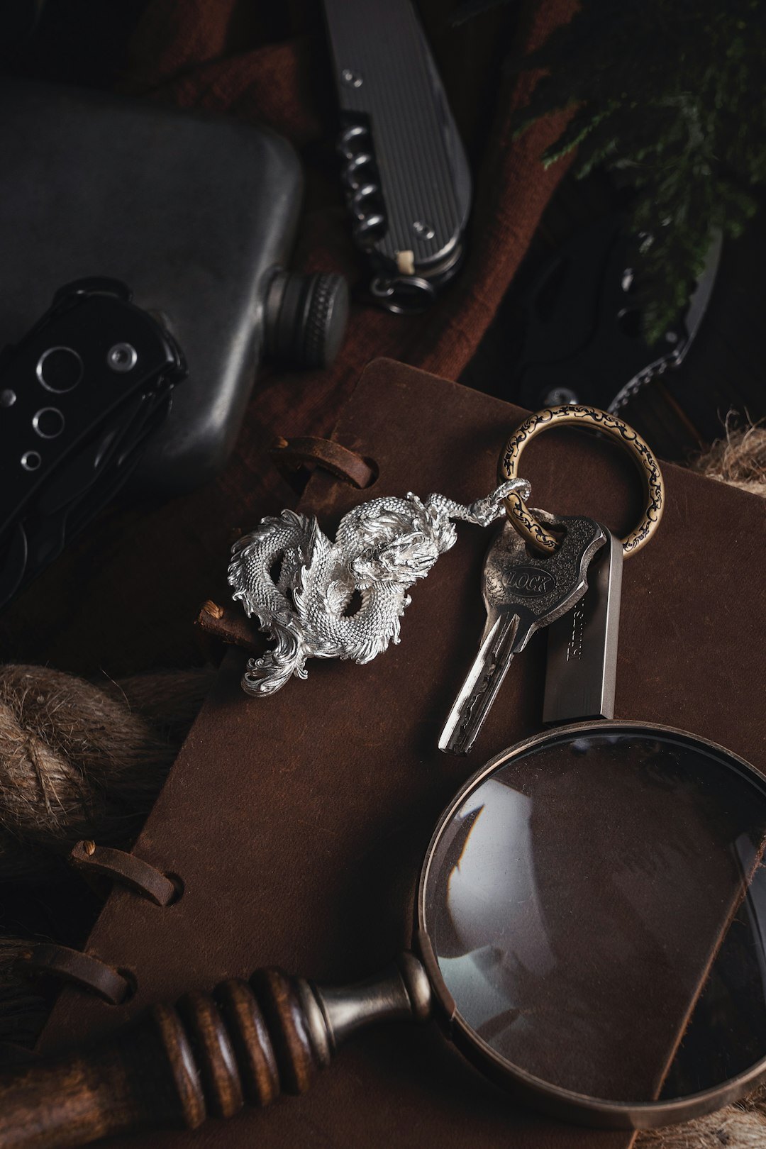 Book cover with an old key and magnifying glass on dark background