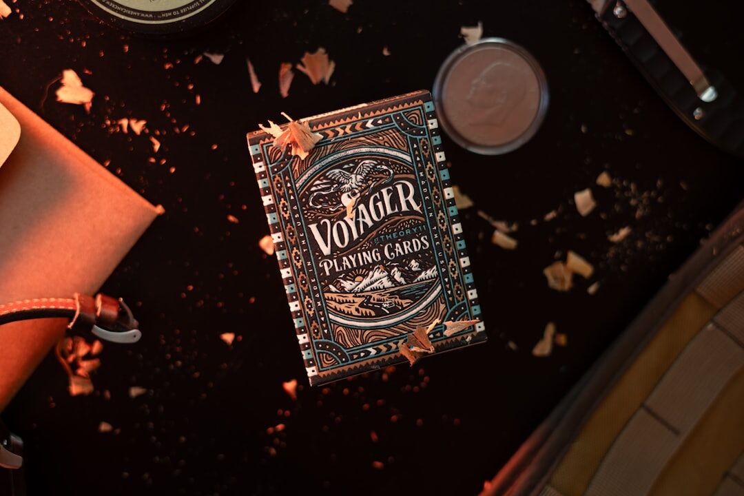Book cover with a vintage revolver and playing cards on dark table