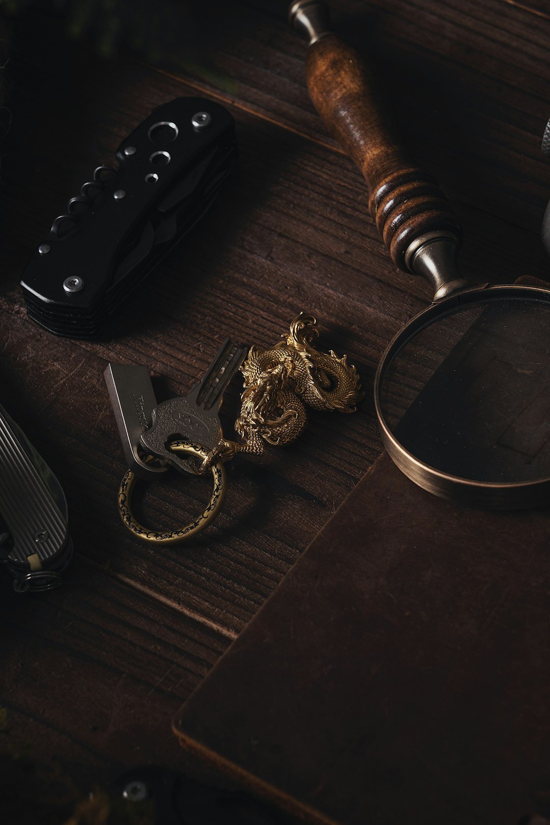 Top-down view of a desk with a detective novel, coffee and a magnifying glass