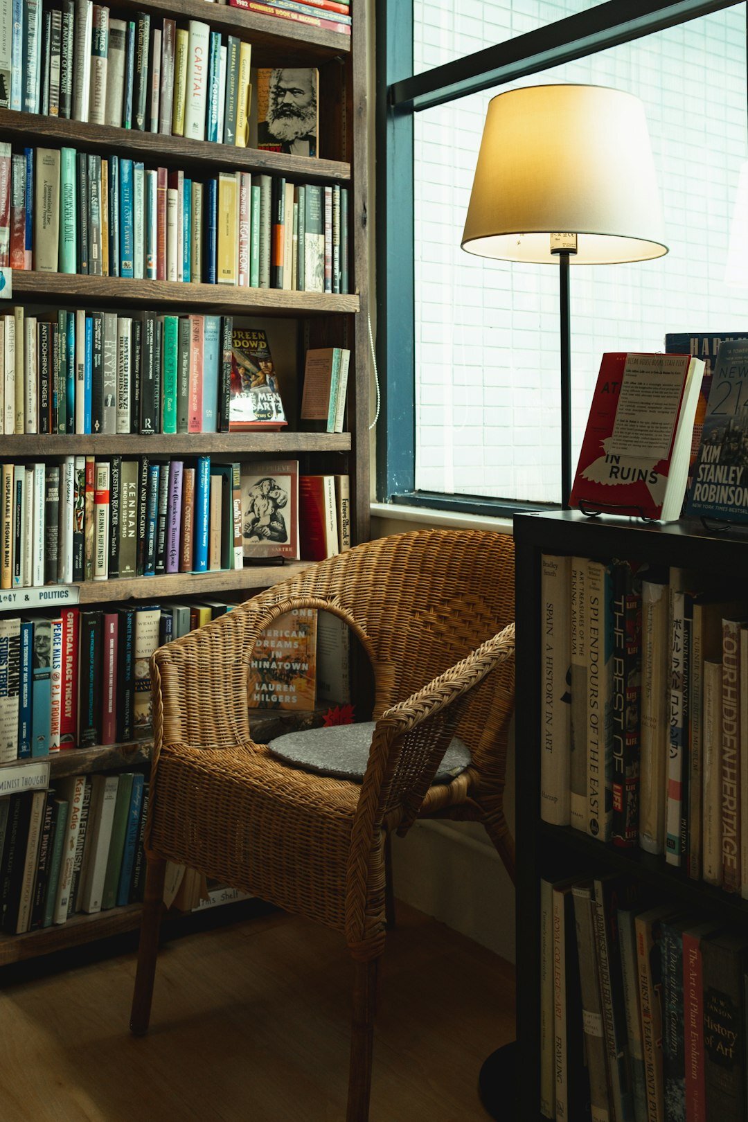 Reading corner in a bookstore with a leather armchair and stacks of detective novels