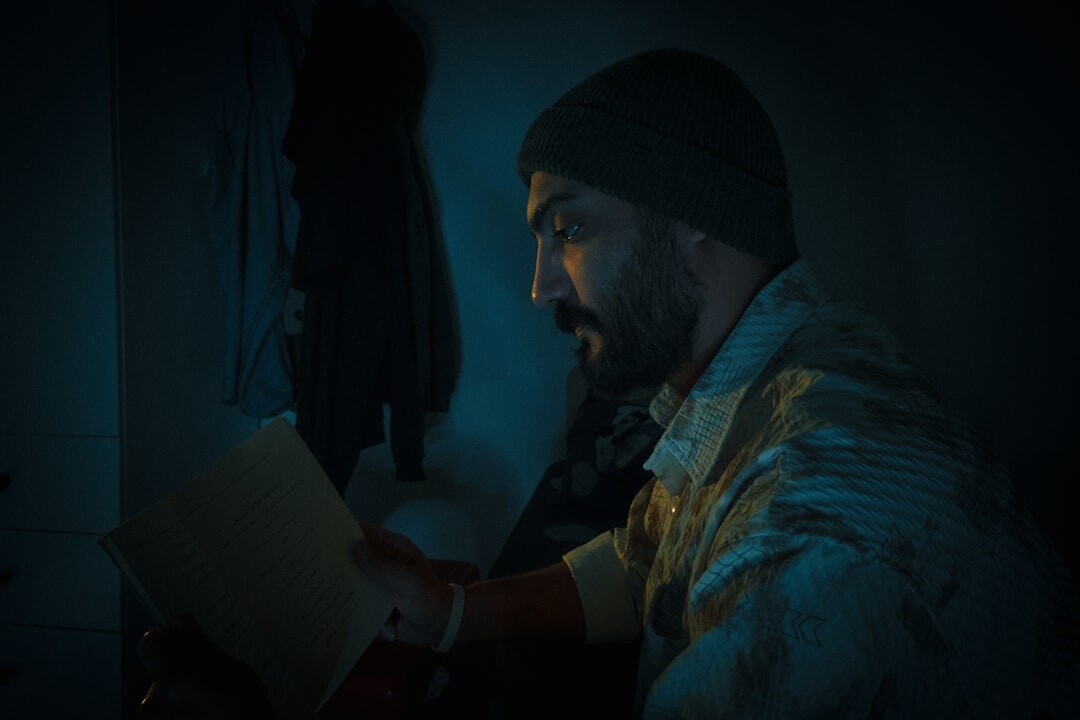 detective reading book at night
